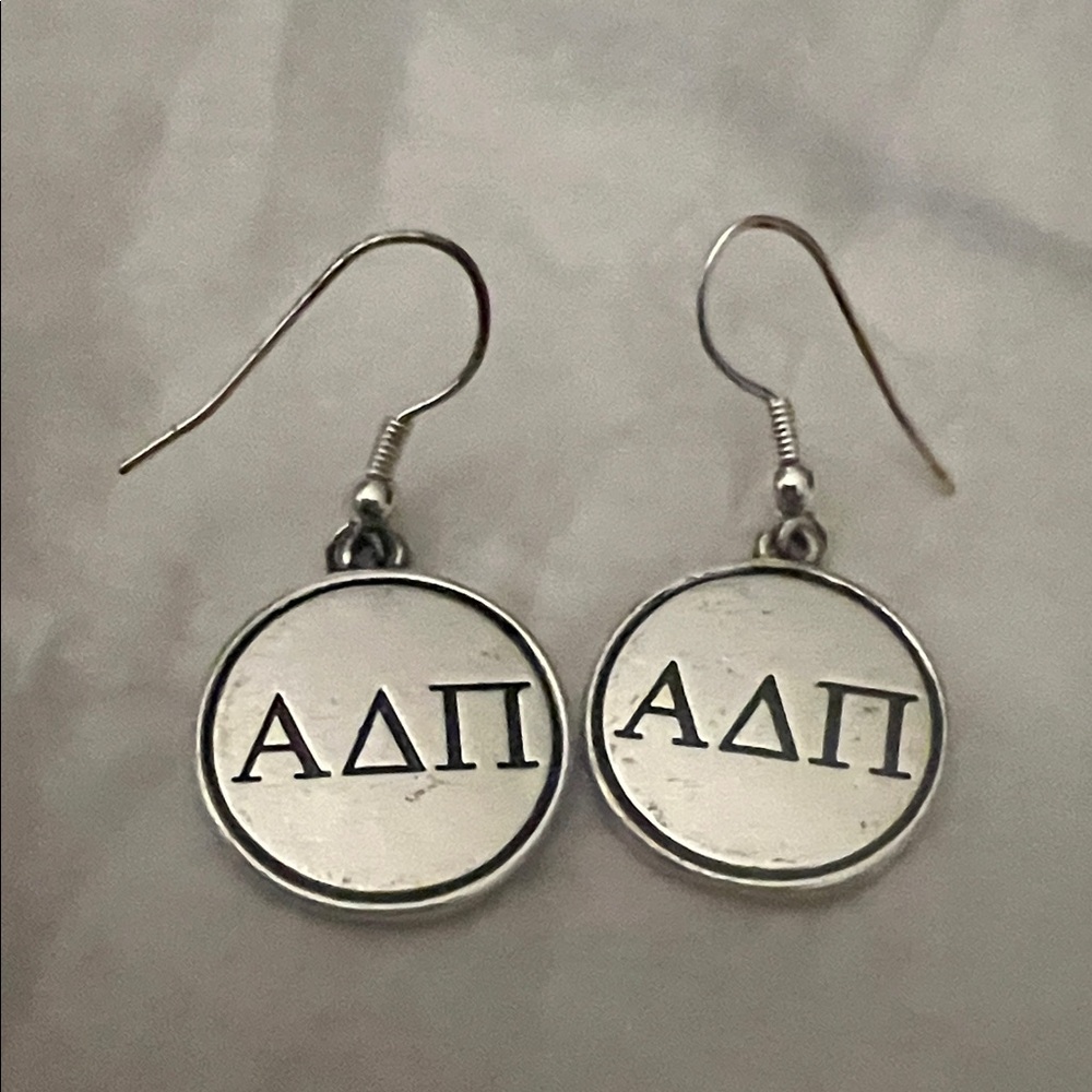 Silver Alpha Delta Pi sorority earrings.